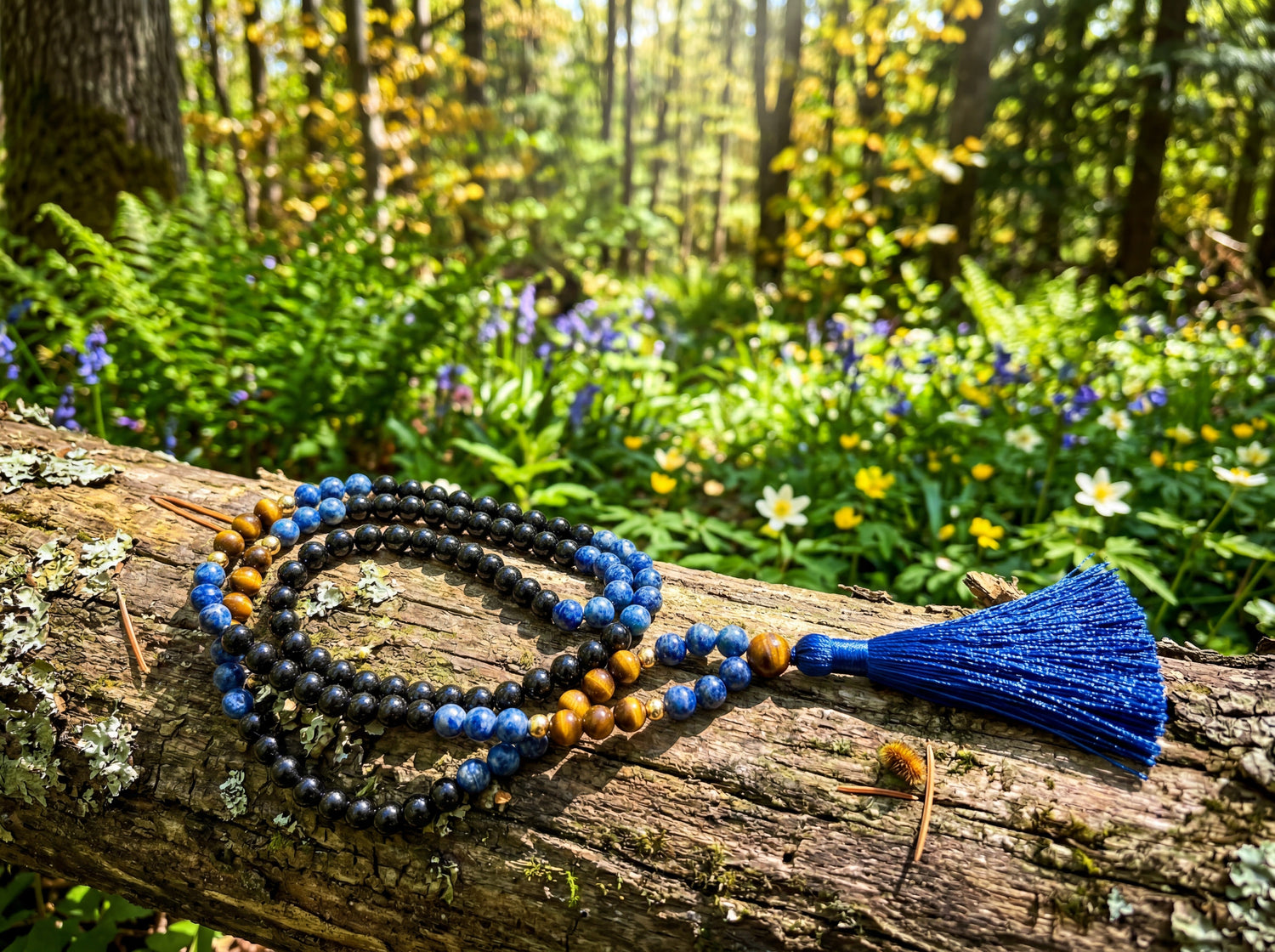 long beautiful long beaded necklaces used for meditation, and they are sitting on a green forest floor
