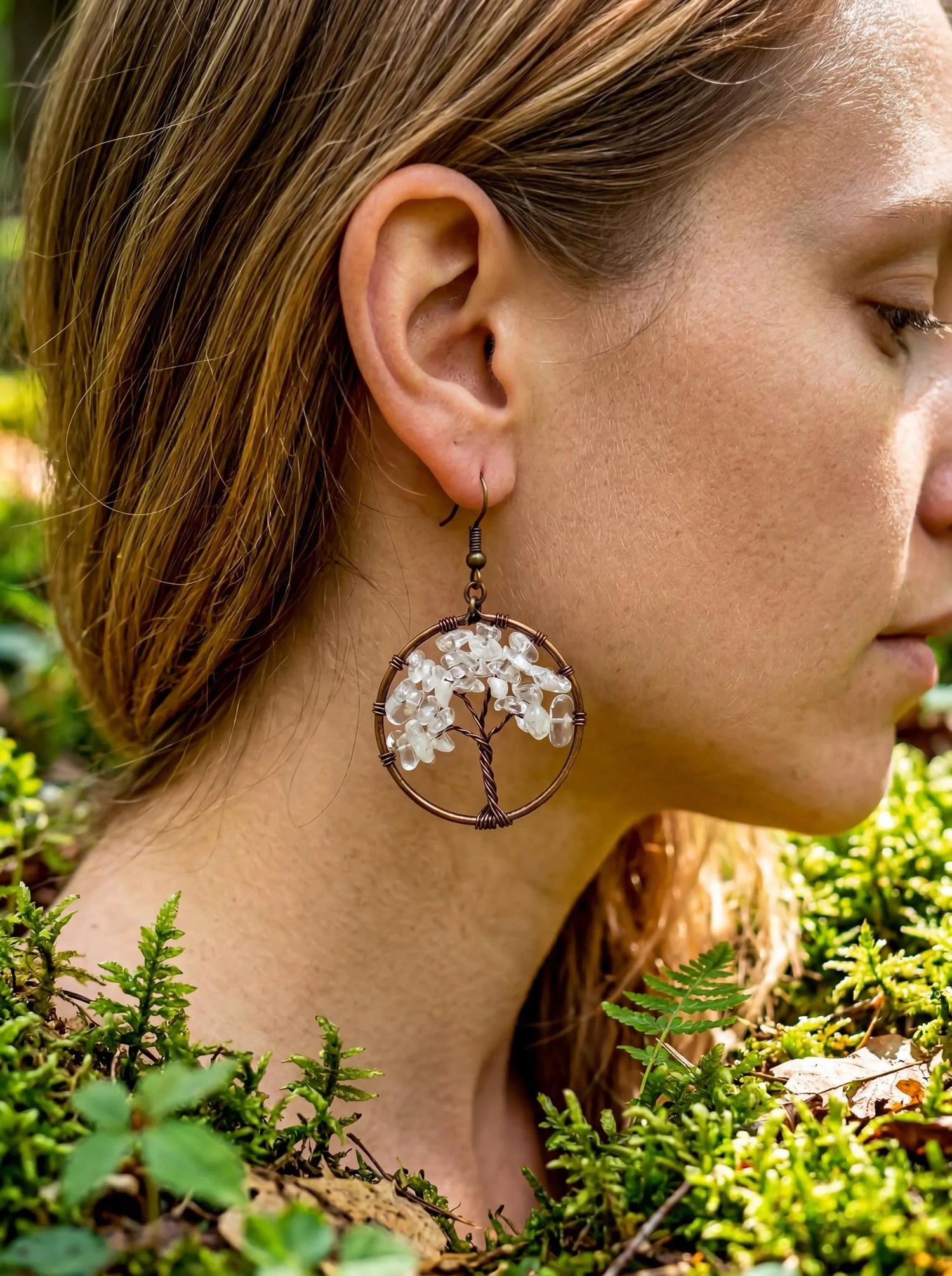 wire wrapped earrings that are made into the tree of life pattern