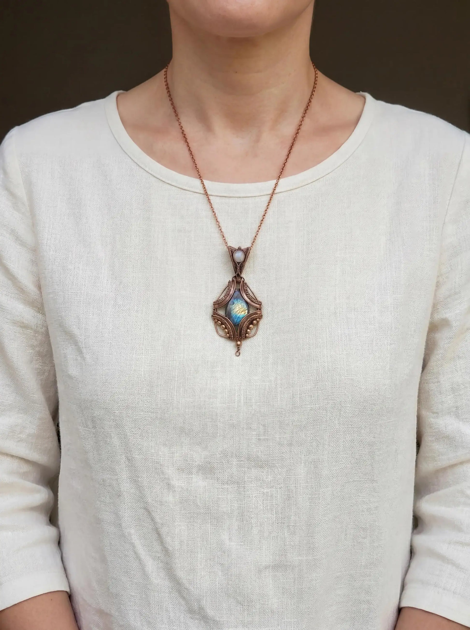 Handcrafted wire-wrapped pendant with iridescent stone, copper chain, artisan jewelry